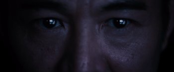 Movie still from “The Expendables” (2010), directed by Sylvester Stallone – View of a man's eyes with dark lighting; Extreme Close Up shot, Low angle
