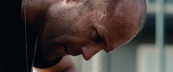 Movie still from “The Expendables” (2010), directed by Sylvester Stallone – A man's face with his eyes closed; Close Up shot, Low angle