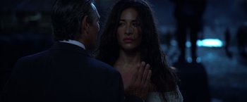 Movie still from “The Expendables” (2010), directed by Sylvester Stallone – A man and a woman standing next to each other in the dark; Close Up shot, Over the shoulder angle