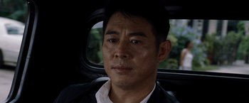 Movie still from “The Expendables” (2010), directed by Sylvester Stallone – A person sitting in a car; Close Up shot, Over the shoulder angle