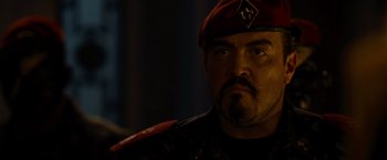 Movie still from “The Expendables” (2010), directed by Sylvester Stallone – A person wearing a hat; Close Up shot, Low angle