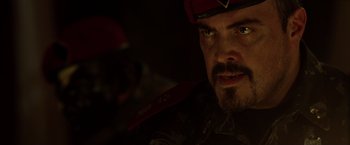 Movie still from “The Expendables” (2010), directed by Sylvester Stallone – A person wearing a military uniform; Close Up shot, Over the shoulder angle