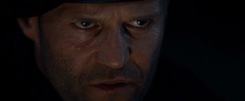 Movie still from “The Expendables” (2010), directed by Sylvester Stallone – A man's face with a hat on; Extreme Close Up shot, Low angle