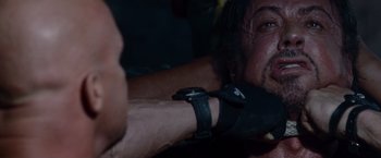 Movie still from “The Expendables” (2010), directed by Sylvester Stallone – Sylvester stallone's arm and wrist; Close Up shot, Over the shoulder angle
