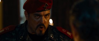 Movie still from “The Expendables” (2010), directed by Sylvester Stallone – A person wearing a military uniform; Close Up shot, Over the shoulder angle