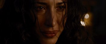 Movie still from “The Expendables” (2010), directed by Sylvester Stallone – A woman's face with tears coming out of her eyes; Close Up shot, Low angle