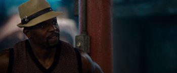 Movie still from “The Expendables” (2010), directed by Sylvester Stallone – A person wearing a hat; Close Up shot, Over the shoulder angle