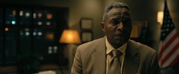 Movie still from “The Fall of the House of Usher” (2023), directed by Mike Flanagan – An older man wearing a suit and tie; Close Up shot, Over the shoulder angle