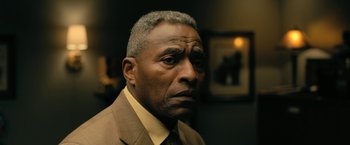 Movie still from “The Fall of the House of Usher” (2023), directed by Mike Flanagan – An older man wearing a suit and tie looking at the camera; Close Up shot, Low angle