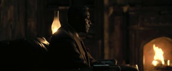 Movie still from “The Fall of the House of Usher” (2023), directed by Mike Flanagan – A man sitting in a chair in a dark room; Close Up shot, Over the shoulder angle