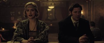 Movie still from “The Fall of the House of Usher” (2023), directed by Mike Flanagan – A man and a woman sitting at a dinner table; Medium shot, Over the shoulder angle