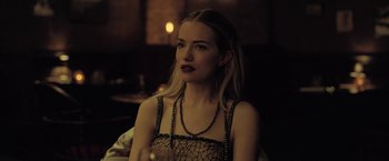 Movie still from “The Fall of the House of Usher” (2023), directed by Mike Flanagan – A woman sitting in front of a mirror in a room; Close Up shot, Over the shoulder angle