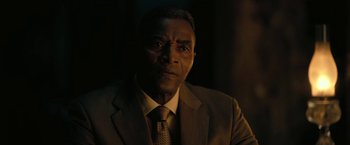 Movie still from “The Fall of the House of Usher” (2023), directed by Mike Flanagan – A man wearing a suit and tie in the dark; Close Up shot, Low angle