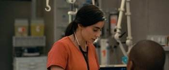 Movie still from “The Fall of the House of Usher” (2023), directed by Mike Flanagan – A woman with a stethoscope around her neck in an operating room; Close Up shot, Over the shoulder angle