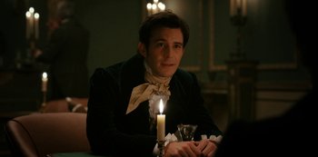 Movie still from “Bridgerton” (2020), created by Chris Van Dusen – A man sitting in front of a lit candle; Medium shot, Over the shoulder angle