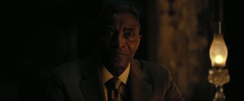 Movie still from “The Fall of the House of Usher” (2023), directed by Mike Flanagan – A man wearing a suit and tie in the dark; Close Up shot, Low angle