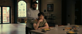 Movie still from “The Fall of the House of Usher” (2023), directed by Mike Flanagan – A man standing next to a man sitting at a table; Medium shot, Over the shoulder angle