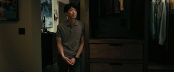 Movie still from “The Fall of the House of Usher” (2023), directed by Mike Flanagan – A man standing next to a closet in a room; Medium shot, Low angle