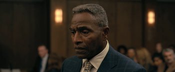 Movie still from “The Fall of the House of Usher” (2023), directed by Mike Flanagan – An older man wearing a suit and tie; Close Up shot, Over the shoulder angle