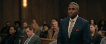 Movie still from “The Fall of the House of Usher” (2023), directed by Mike Flanagan – A man in a suit and tie in a court room; Medium shot, Over the shoulder angle
