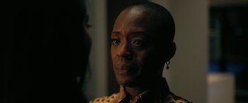 Movie still from “The Fall of the House of Usher” (2023), directed by Mike Flanagan – A person wearing a yellow shirt; Close Up shot, Over the shoulder angle