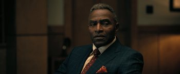 Movie still from “The Fall of the House of Usher” (2023), directed by Mike Flanagan – An older man in a suit and a tie; Close Up shot, Over the shoulder angle