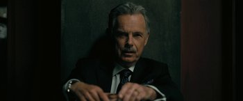 Movie still from “The Fall of the House of Usher” (2023), directed by Mike Flanagan – An older man wearing a suit and tie; Close Up shot, Low angle