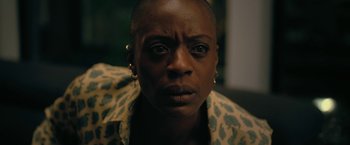 Movie still from “The Fall of the House of Usher” (2023), directed by Mike Flanagan – A person with short black hair; Close Up shot, High angle