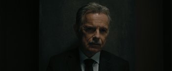 Movie still from “The Fall of the House of Usher” (2023), directed by Mike Flanagan – An older man wearing a suit and tie; Close Up shot, Low angle