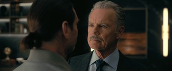 Movie still from “The Fall of the House of Usher” (2023), directed by Mike Flanagan – An older man in a suit and tie talking to a younger man in a suit and tie; Close Up shot, Over the shoulder angle