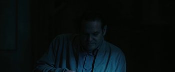 Movie still from “The Fall of the House of Usher” (2023), directed by Mike Flanagan – A man is looking at his cell phone in the dark; Close Up shot, High angle