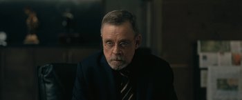 Movie still from “The Fall of the House of Usher” (2023), directed by Mike Flanagan – An older man wearing a suit and tie; Close Up shot, Over the shoulder angle