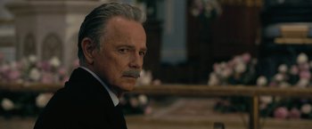 Movie still from “The Fall of the House of Usher” (2023), directed by Mike Flanagan – An older man in a suit with a mustache; Close Up shot, Over the shoulder angle