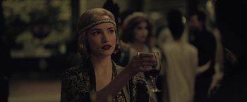 Movie still from “The Fall of the House of Usher” (2023), directed by Mike Flanagan – A woman holding a glass of red wine in her hand; Close Up shot, Over the shoulder angle