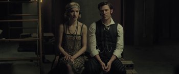 Movie still from “The Fall of the House of Usher” (2023), directed by Mike Flanagan – A man and a woman sitting next to each other; Medium shot, Low angle