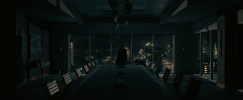 Movie still from “The Fall of the House of Usher” (2023), directed by Mike Flanagan – A man standing in front of an empty conference table; Extreme Wide shot, Over the shoulder angle