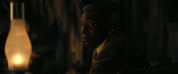 Movie still from “The Fall of the House of Usher” (2023), directed by Mike Flanagan – A man in a suit and tie looking into the distance; Close Up shot, Over the shoulder angle