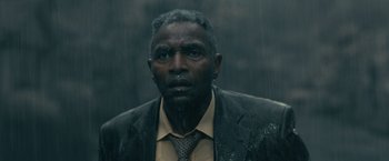 Movie still from “The Fall of the House of Usher” (2023), directed by Mike Flanagan – A man in a suit and tie in the pouring rain; Close Up shot, Low angle