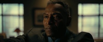 Movie still from “The Fall of the House of Usher” (2023), directed by Mike Flanagan – A person wearing a suit and tie; Close Up shot, Low angle