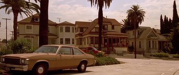Movie still from “The Fast and the Furious” (2001), directed by Rob Cohen – A car parked in a parking lot near a palm tree; Wide shot, Low angle