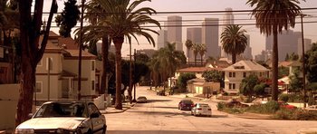Movie still from “The Fast and the Furious” (2001), directed by Rob Cohen – A view of palm trees and buildings in a city; Extreme Wide shot, High angle
