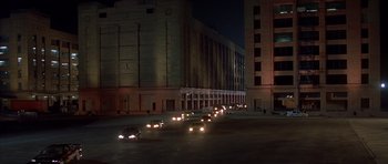 Movie still from “The Fast and the Furious” (2001), directed by Rob Cohen – A bunch of cars driving down a street at night; Extreme Wide shot, High angle