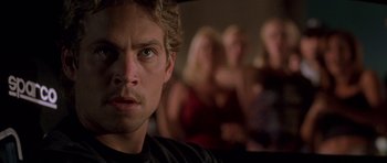 Movie still from “The Fast and the Furious” (2001), directed by Rob Cohen – A person looking at the camera; Close Up shot, Over the shoulder angle