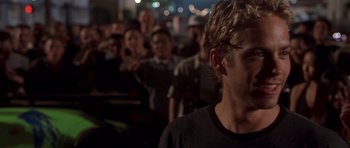 Movie still from “The Fast and the Furious” (2001), directed by Rob Cohen – A group of people standing in front of each other; Close Up shot, Over the shoulder angle