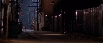 Movie still from “The Fast and the Furious” (2001), directed by Rob Cohen – An empty street at night with lights on the side; Extreme Wide shot, High angle