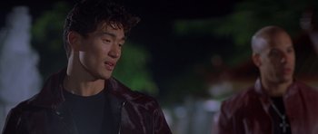 Movie still from “The Fast and the Furious” (2001), directed by Rob Cohen – A man in a leather jacket looking to his left; Close Up shot, Over the shoulder angle