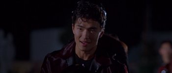 Movie still from “The Fast and the Furious” (2001), directed by Rob Cohen – A young man with dark hair wearing a leather jacket; Close Up shot, Over the shoulder angle