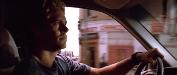 Movie still from “The Fast and the Furious” (2001), directed by Rob Cohen – A man driving a car in the street; Close Up shot, Over the shoulder angle