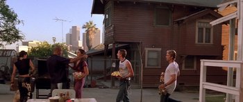 Movie still from “The Fast and the Furious” (2001), directed by Rob Cohen – A group of people walking down a street; Wide shot, Low angle