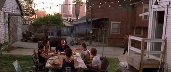 Movie still from “The Fast and the Furious” (2001), directed by Rob Cohen – A group of people sitting at a table eating food; Wide shot, High angle